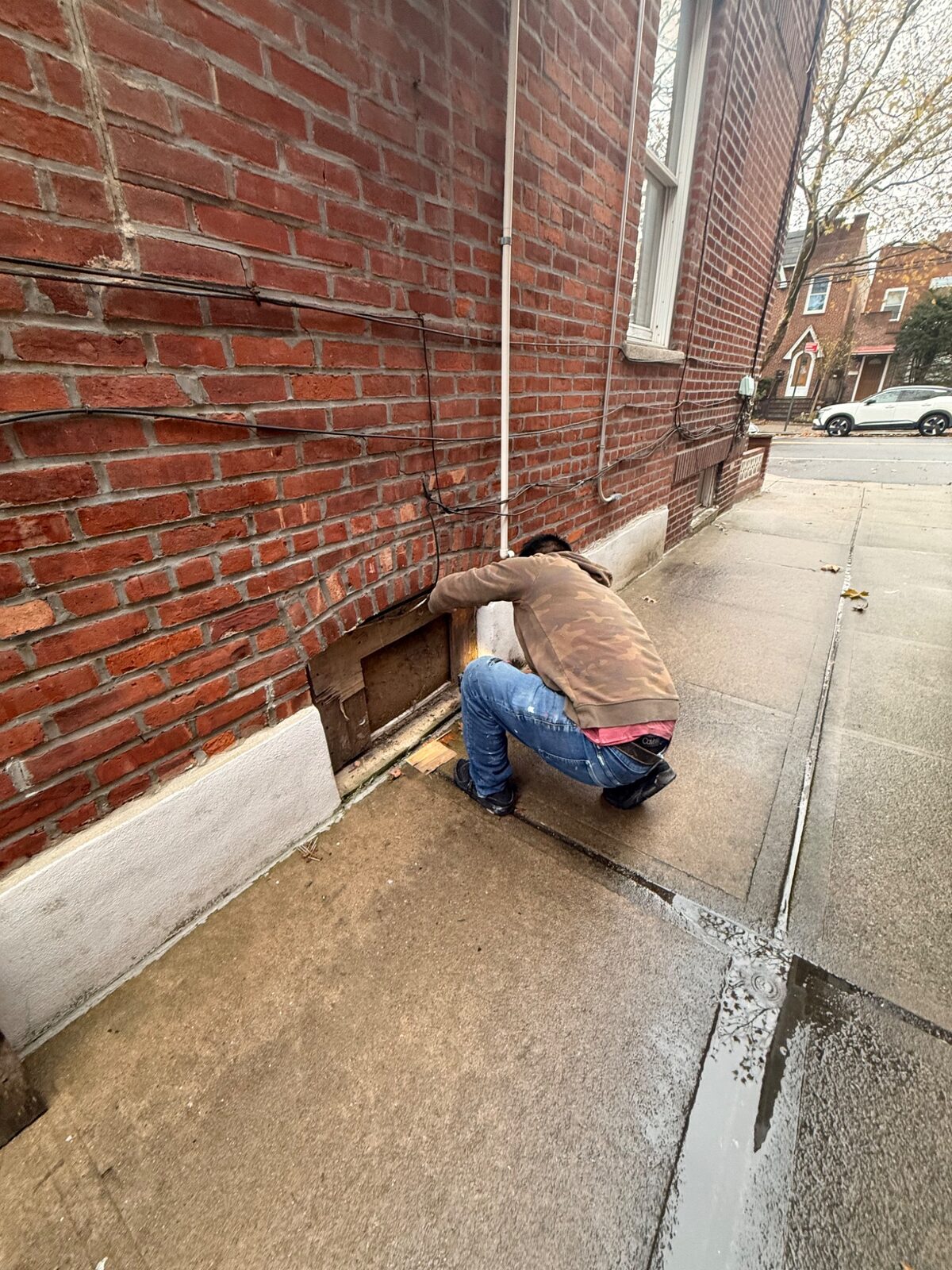 Crew preparing ground-level window opening at managed property