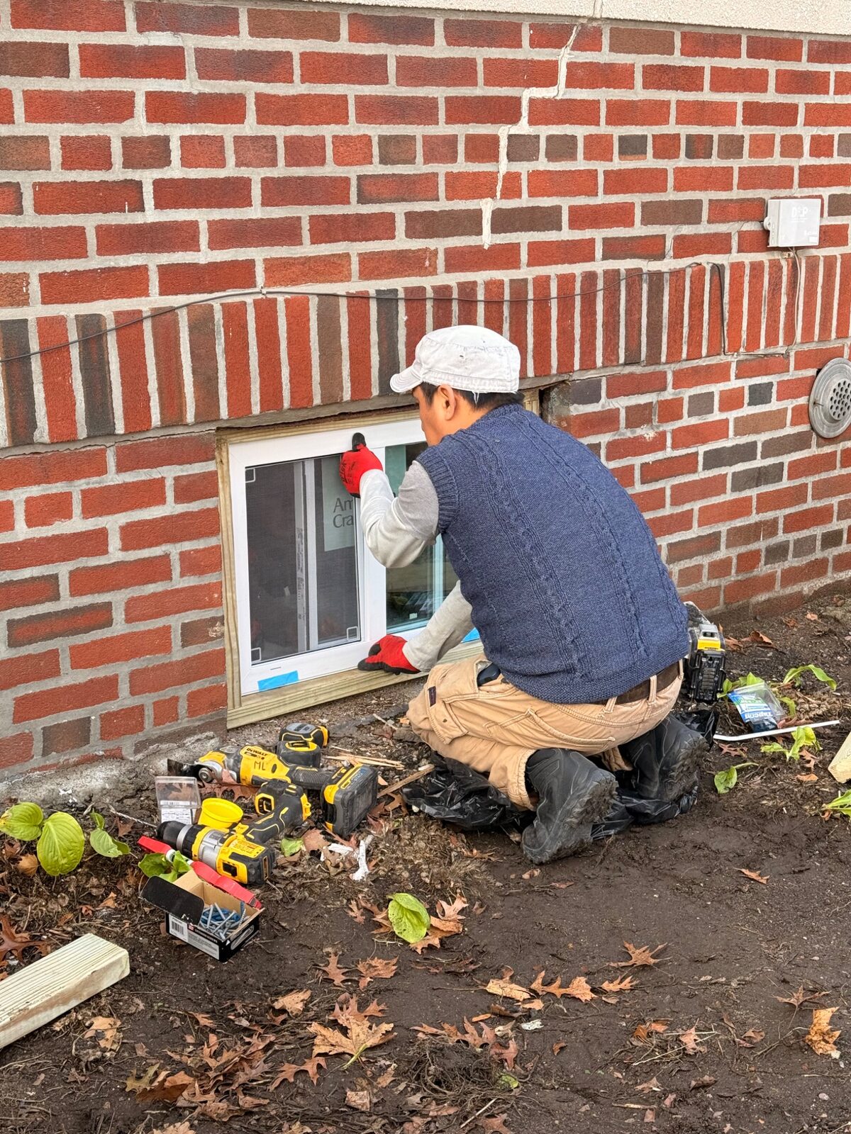Crew installing window at property exterior